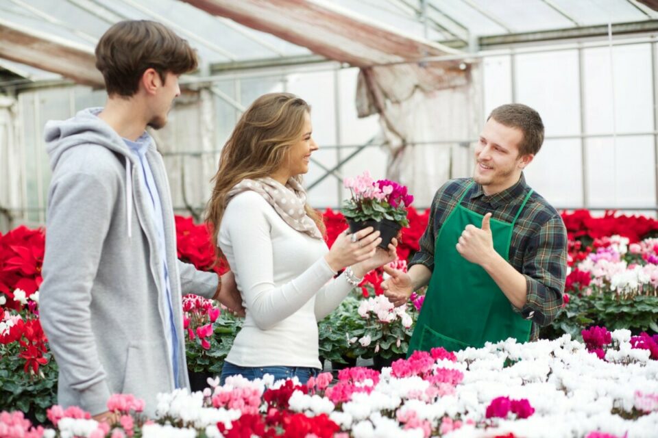 couple buying flowers from a flower shop owner